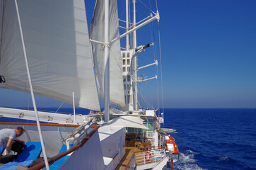 Windjammer sailing yacht cruiseship cruise ship liner at sea during twilight

