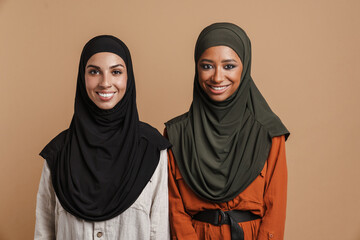 Young muslim women in hijab smiling and looking at camera