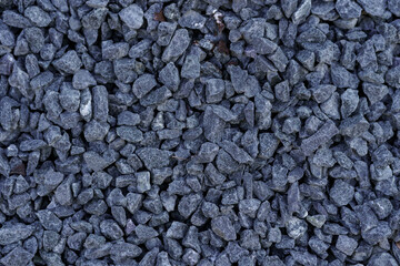 Gray small rocks ground texture. Dark gray small road stone background. Gravel pebbles stone seamless texture.