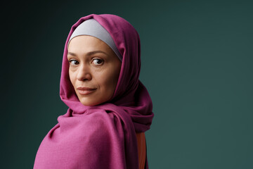 Middle eastern woman in hijab posing and looking at camera