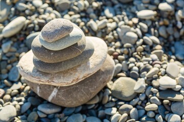 Fototapeta na wymiar Balancing sea stone on beach background