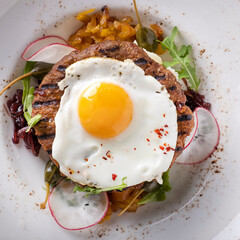 Beef steak with fried egg. Top view, closeup