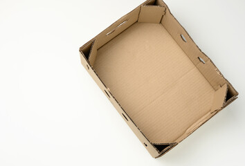 rectangular empty cardboard box of brown paper on a white background, box without a lid for...