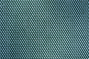 Abstract green metal background. Iron dots texture on outdoor metal wall.