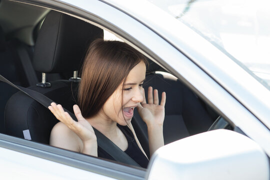 fear of driving,driver girl screams at the wheel, is afraid to drive a car