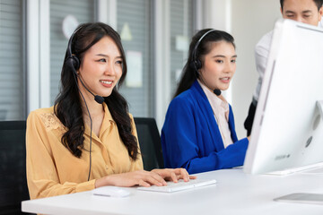 woman operator wearing headphones and talking online with customer at call center service