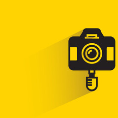 camera on selfie stick yellow background