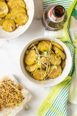 Korean cucumber salad, with  chili pepper, soy sauce and sprouts. White background and green towel