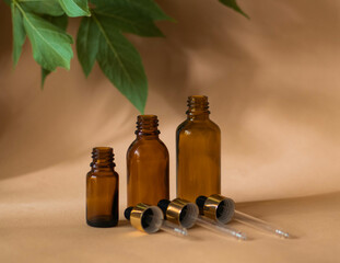 Three cosmetic bottles with a pipette