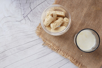 Tasty oats bars on a plate and glass of milk on table ,