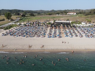 Fototapeta premium Aerial view of kanali beach crowded with tourists, famous tourist destination in preveza, epirus, greece