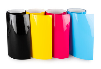 Row of CMYK colored vinyl car wrapping or plotter cutting sticker foil film rolls isolated white...