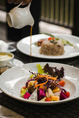 Bowl of healthy fresh fruit salad  with sauce


