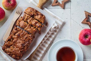Apple bread on a wooden board. Autumn fruit pie, gray background.