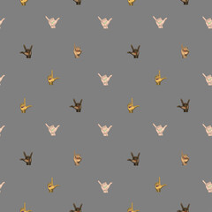 A small-patterned symmetrical modern seamless pattern from the American sign language I love you on a gray background.