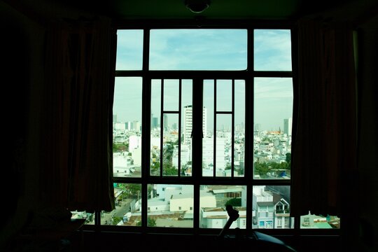 Wind coming through colorful curtain and iron window grilles from the blue sky