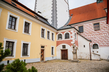 Fototapeta na wymiar Pelhrimov, Czech Republic, 03 July 2021: gothic church of St. Bartholomew with observation tower at sunny summer day in center of town, sgraffito plaster in the form of red and white bricks on walls
