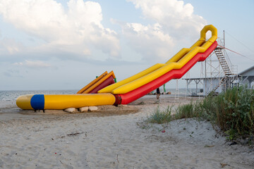 inflatable slide on the sand by the sea