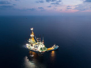 Offshore Jack Up Rig in The Middle of The Sea at Sunset Time for Petroluem Exploration and...