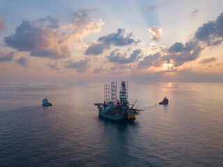 Offshore drilling rig (jack up rig) and tow vessels during the rig move operation in the middle of...
