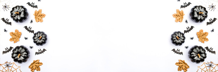 Banner. Modern background with bats, black and gold pumpkins, leaves, cobwebs, spiders on a white background. Halloween with copy space for text. Flat lay, top.
