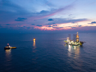 Fototapeta premium Offshore Jack Up Rig in The Middle of The Sea at Sunset Time for Petroluem Exploration and Production