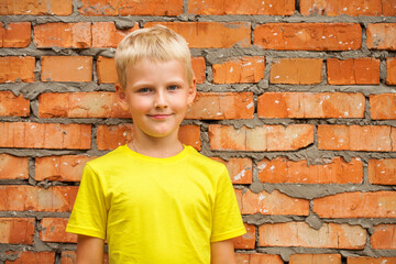 Blonde little boy in a summer park