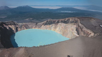 A lifeless acid lake in the caldera of an extinct volcano. Turquoise water with yellow sulfur...