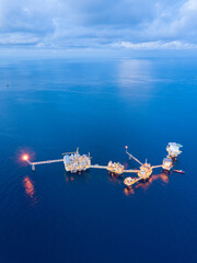 Central processing platform (cpp) in the middle of the ocean during sunset time - upstream industry.