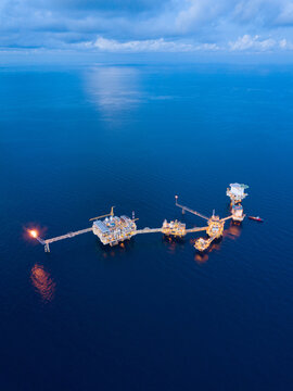 Central processing platform (cpp) in the middle of the ocean during sunset time - upstream industry.