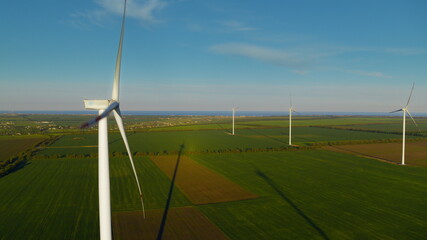 Fototapeta na wymiar Aerial view of windmill farm producing power. Windmills creating natural energy.