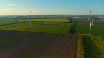 View of wind generators producing clean alternative energy in rural landscape.