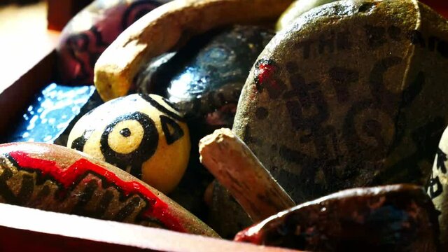 Abstract painted Viking drawing patterned spiritual stones colourful hobby art collection in wooden box with burning incense