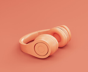 Monochrome orange color professional headphone on the floor in a pink studio, 3d rendering