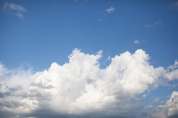 Big white clouds in a blue sky close-up. There is a place for the text. The concept of cleanliness in nature and caring for nature