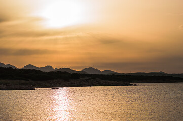 beautiful sea at sunset with rocks and mountains in the background.Sardinia