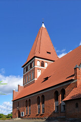Obraz premium General view and architectural details of the Catholic Church of Our Lady Queen of Poland, built in 1894 in the Gothic style, in Pisanica in Masuria, Poland.