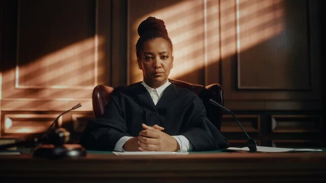 Cinematic Court of Law Trial: Portrait of Impartial Thoughtful Female Judge Looking at Camera. Wise, Incorruptible, Fair Justice Doing Her Job Professionally, Sentencing Criminals, Protecting Innocent