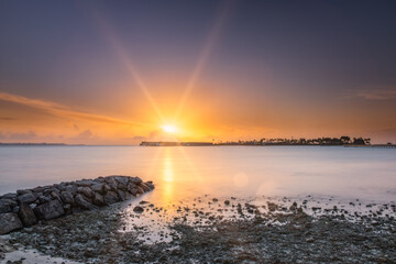 Beautiful vivid sunrise over beach with the villas in the Indian ocean, Maldives. Crossroads Maldives, hard rock hotel, july 2021