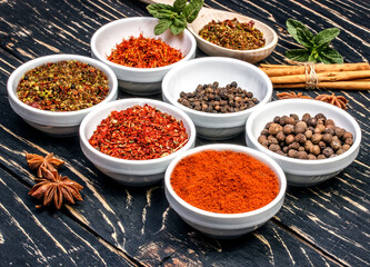 Colorful aromatic Indian spices and herbs on an old oak wooden brown backgrownd