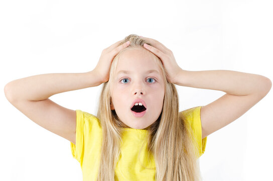 Shot of female kid posing on camera with eyes and mouth wide open being emotional and surprised. Isolated on white background
