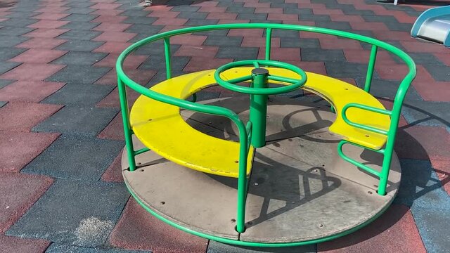 green and yellow color children carouse  on playground