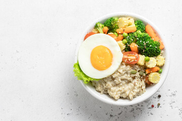 Savory oats veggie egg bowl. Space for text, top view.