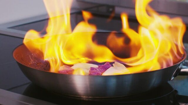 Cooking on fire in a frying pan flamber