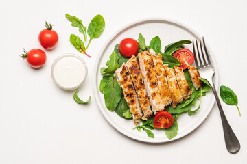 Chopped chicken breast steak with salad. White background with copy space