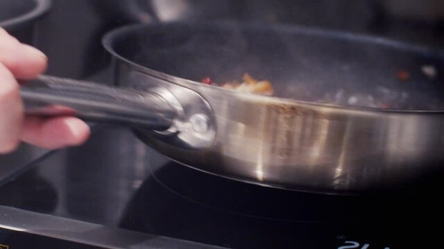 shrimp with hot peppers fried in a frying pan