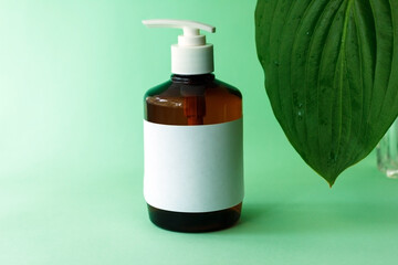 One cosmetic dark amber glass bottle on green background. Closeup, copy space. Beauty blog, salon treatment concept, minimalism brand packaging mock up