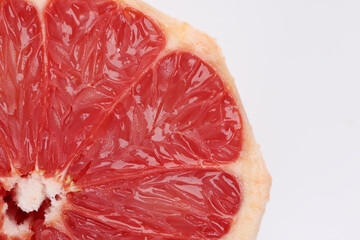 Ruby red grapefruit closeup macro pulp on white background