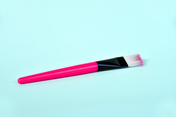 Face brush in pink color isolated on color background