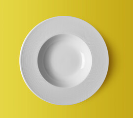 white ceramic plate on yellow